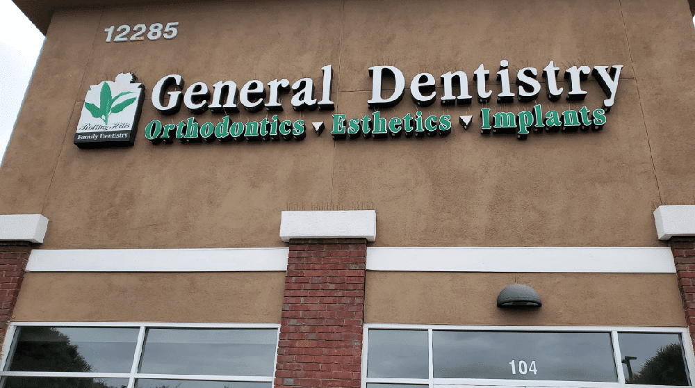 Exterior sign of a dental clinic in Poway offering general dentistry, orthodontics, esthetics, and implants.