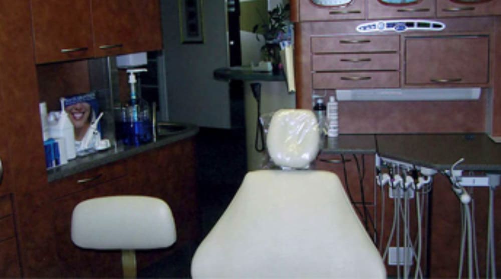 Modern dental treatment room in Poway featuring a comfortable dentist chair, advanced dental tools, and a clean, organized workspace for patient care.
